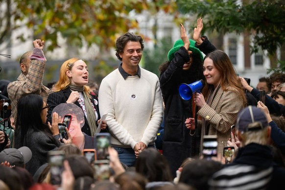 LONDON, ENGLAND - NOVEMBER 09: Andrew, the second runner-up in a Harry Styles lookalike competition, is cheered by fans of the former One Direction singer during a round of judging at Soho Square on N ...