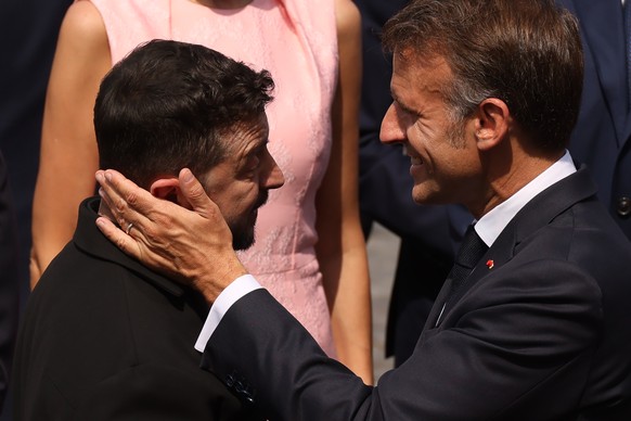 French President Emmanuel Macron, right, speaks with Ukraine's President Volodymyr Zelensky after the Bastille Day military parade on the Champs-Elysees avenue, in Paris, Tuesday, July 14, 2026.  ...