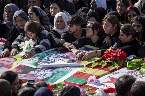 Syrian Kurds attend a funeral of people killed in Turkish airstrikes in the village of Al Malikiyah , northern Syria, Monday, Nov. 21, 2022. The airstrikes, which Turkey said were aimed at Kurdish mil ...