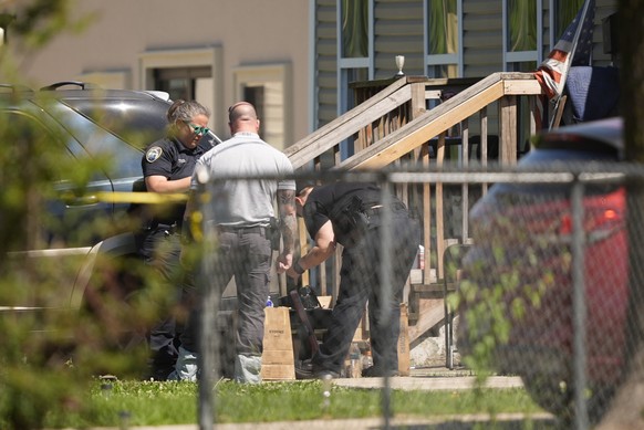 Police work outside the scene of a mass shooting, Sunday, April 19, 2026. (AP Photo/Gerald Herbert)