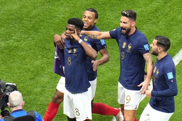 France's Aurelien Tchouameni, centre, celebrates after scoring his side's opening goal during the World Cup quarterfinal soccer match between England and France, at the Al Bayt Stadium in Al Khor, Qat ...