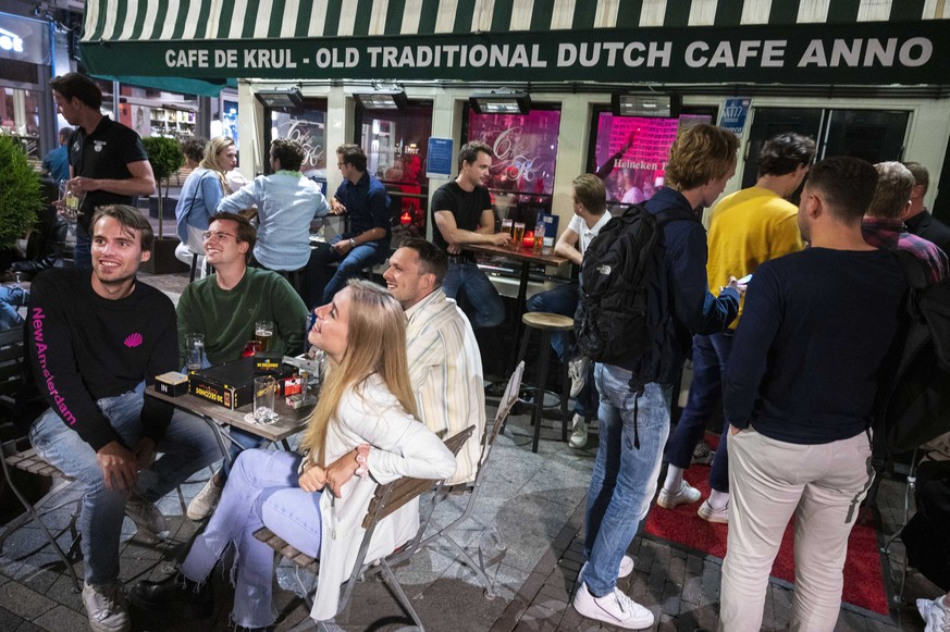 epa09334934 A view of nightlife in Amsterdam, the Netherlands, late 09 July 2021 (issued 10 July 2021). Due to a surge in the number of COVID-19 infections in the Netherlands, starting from 10 July un ...