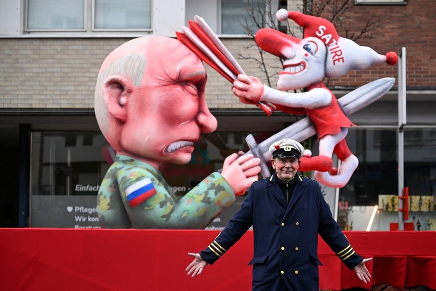 German carnival float builder Jacques Tilly poses for photographers in front of one his creation, a carnival float featuring Russian President Vladimir Putin, during the parade to celebrate Rose Monda ...