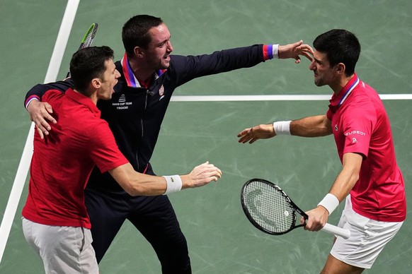 Serbia&#039;s Nikola Cacic, left, Serbia&#039;s captain Viktor Troicki, center, and Novak Djokovic celebrate their team victory over Kazakhstan&#039;s Andrey Golubev and Aleksandr Nedovyesov during a  ...