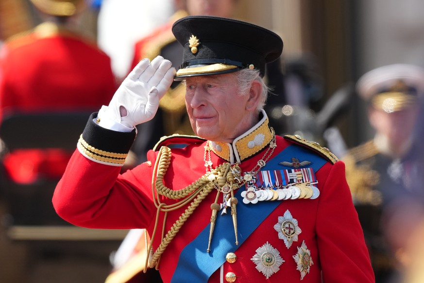 Britain's King Charles III salutes the troops outside Buckingham Palace during Trooping The Colour, the King's annual birthday parade, in London, Saturday, June 13, 2026. (AP Photo/Kirsty Wi ...