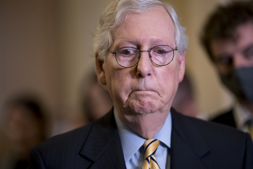 Senate Minority Leader Mitch McConnell, R-Ky., listens as he and the GOP leadership speak to reporters after a weekly GOP policy meeting, at the Capitol in Washington, Tuesday, Sept. 21, 2021. (AP Pho ...