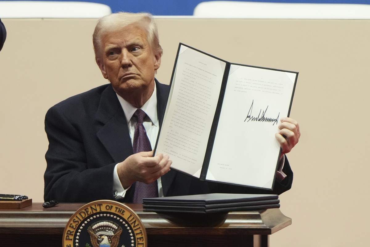 President Donald Trump holds up an executive orders after signing it at an indoor Presidential Inauguration parade event in Washington, Monday, Jan. 20, 2025. (AP Photo/Matt Rourke