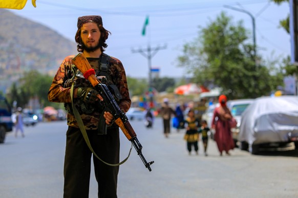 epa10805724 A Taliban security official stands guard at a check point in Kabul, Afghanistan, 18 August 2023. A Taliban imposed ban on political parties, citing them as un-Islamic and responsible for d ...