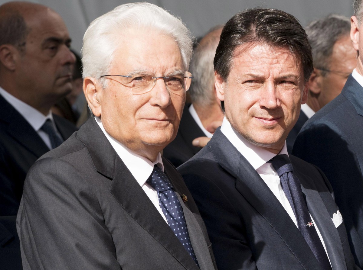 epa07772865 A handout photo made available by the Chigi Palace Press Office shows Italian Prime Minister Giuseppe Conte (R) and Italian President Sergio Mattarella (L) attending a memorial ceremony fo ...