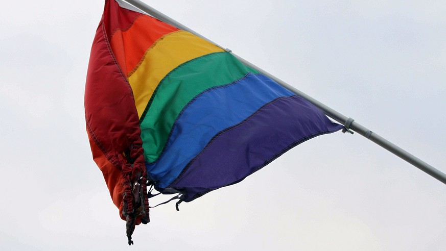 A partially burned flag hangs outside the Identity Inc.&#039;s Gay and Lesbian Community Center on Weds., June 24, 2015, in downtown Anchorage, Alaska. Identity Inc. Executive Director Drew Phoenix sa ...