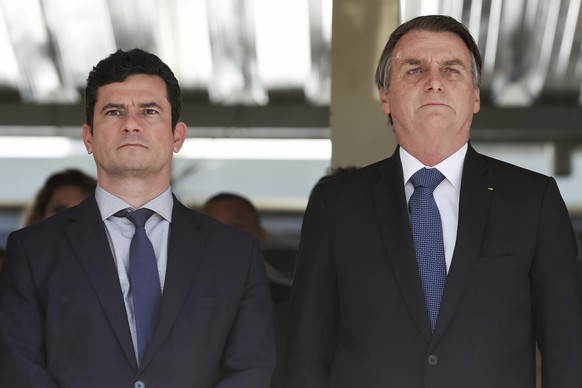 In this photo released by Brazil&#039;s Presidential Press Office, Brazil&#039;s President Jair Bolsonaro, right, and Justice Minister Sergio Moro attend a military ceremony in Brasilia, Brazil, Tuesd ...