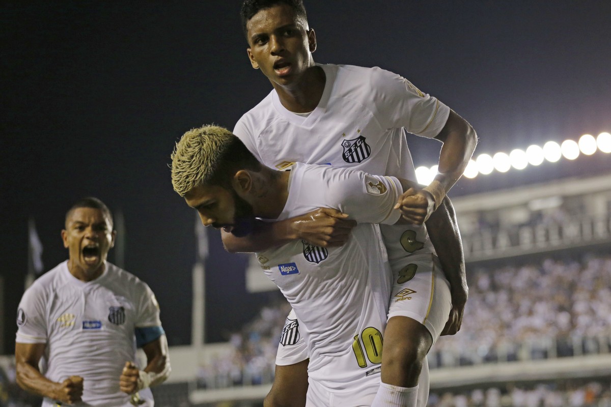 Gabriel Barbosa of Brazil's Santos, bottom, celebrates with teammate Rodrygo after Barbosa scored against Argentina's Estudiantes at a Copa Libertadores soccer match in Santos, Brazil, Tuesd ...