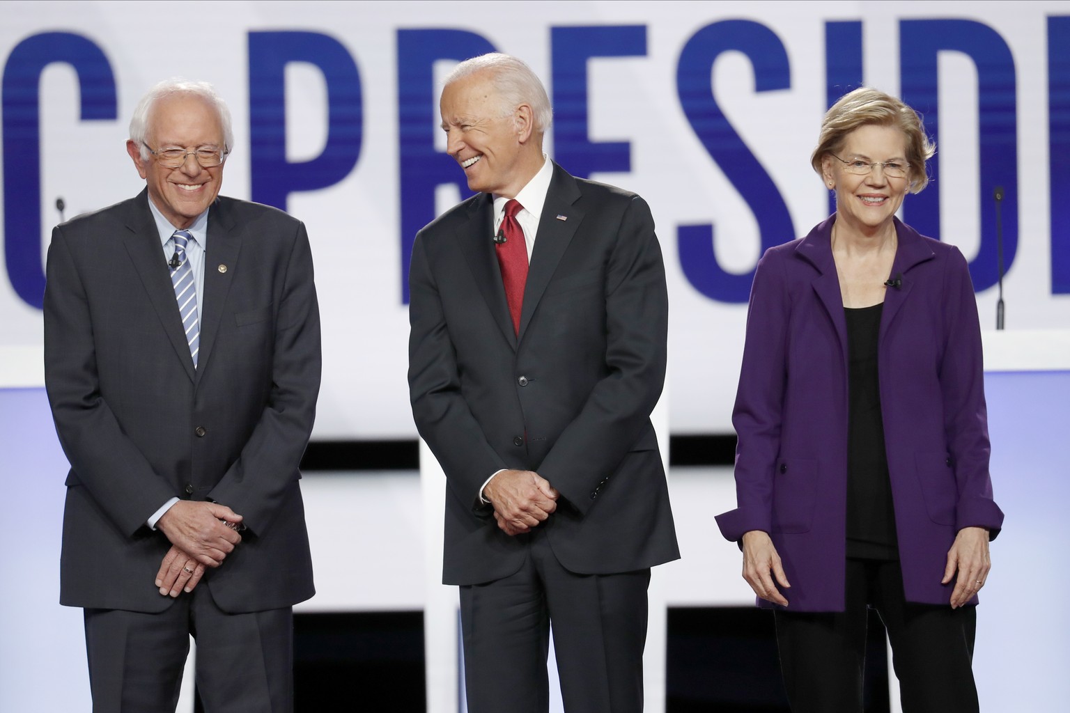 Democratic presidential candidate Sen. Bernie Sanders, I-Vt., former Vice President Joe Biden, center, and Sen. Elizabeth Warren, D-Mass., right, stand on stage before a Democratic presidential primar ...