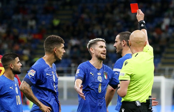 epa09509837 Italian captain Leonardo Bonucci (rear) walks off as referee Sergei Ivanov shows him the red card following his second yellow card during the UEFA Nations League semi final soccer match be ...