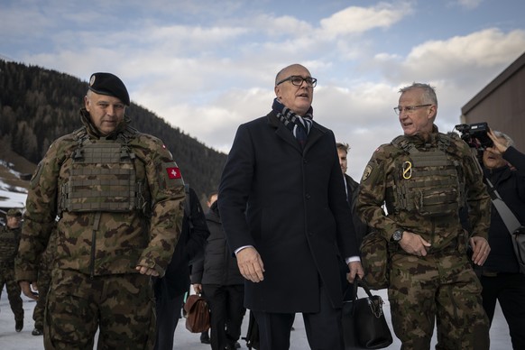 epa12661829 Switzerland's Minister for Defense, Civil Protection and Sport Martin Pfister (C), and Benedikt Roos (L), Chief of the armed forces, with Division Commander Maurizio Dattrino (R) visi ...
