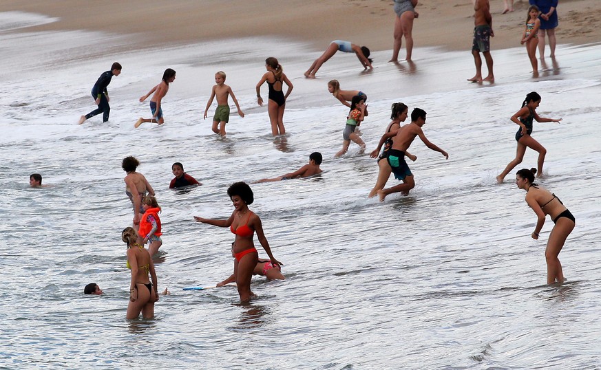 People enjoy the sea at Atlantic Ocean in Biarritz, southwestern France , Wednesday, Oct.26, 2022. Temperatures in southwestern France have mounted all week and were expected to hit over 30° Celcius ( ...