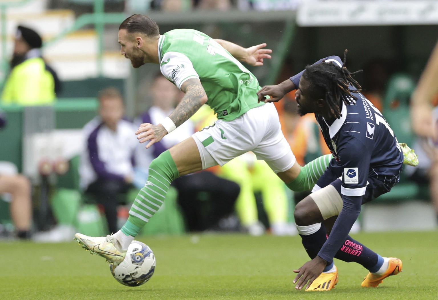 Hibernian&#039;s Martin Boyle, left,and FC Luzern&#039;s Nicky Beloko battle for the ball during their Europa Conference League third qualifying, first leg soccer match at Easter Road, Edinburgh, Thur ...