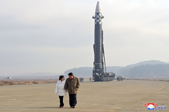 epa10313519 A photo released by the official North Korean Central News Agency (KCNA) shows North Korean leader Kim Jong-Un, accompanied by his daughter during the test firing of a new type of intercon ...