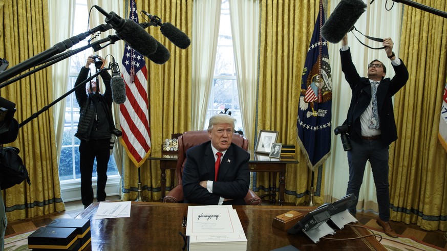 President Donald Trump speaks to reporters after signing the tax bill and continuing resolution to fund the government, in the Oval Office of the White House, Friday, Dec. 22, 2017, in Washington. (AP ...