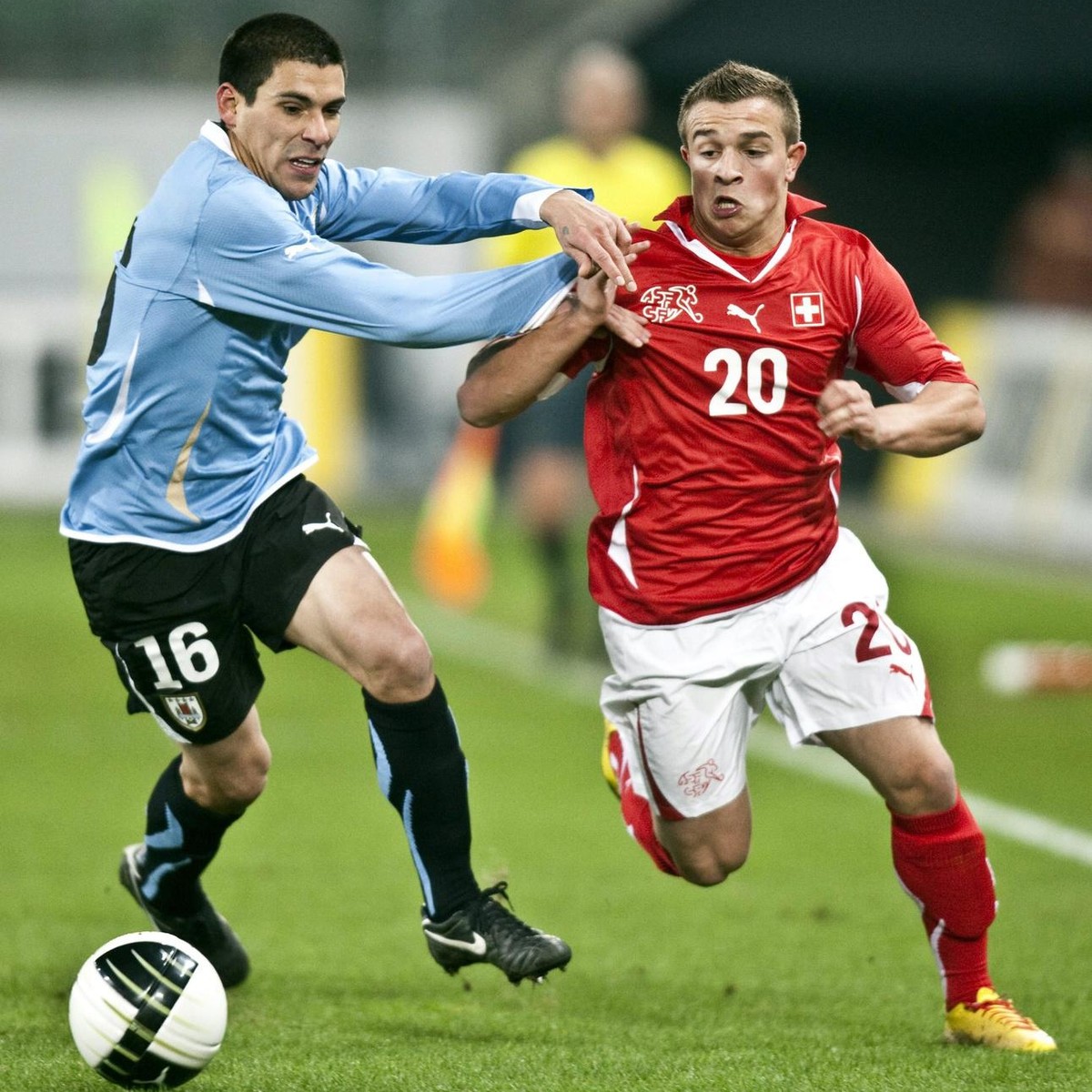 Swiss player Xherdan Shaqiri, right, fights for the ball with Uruguay's Maximiliano Pereira, left, during a friendly test soccer match in the face of the 2010 soccer World Cup in South Africa bet ...