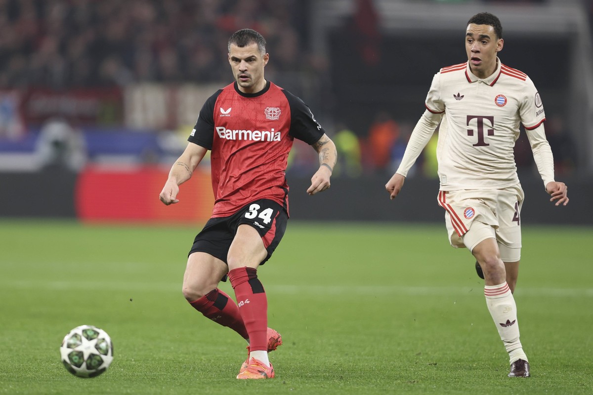 Granit Xhaka Bayer 04 Leverkusen und Jamal Musiala FC Bayern M�nchen battle for the ball during the UEFA Champions League 2024/25 Round of 16 Second Leg match between Bayer 04 Leverkusen and FC Bayern ...