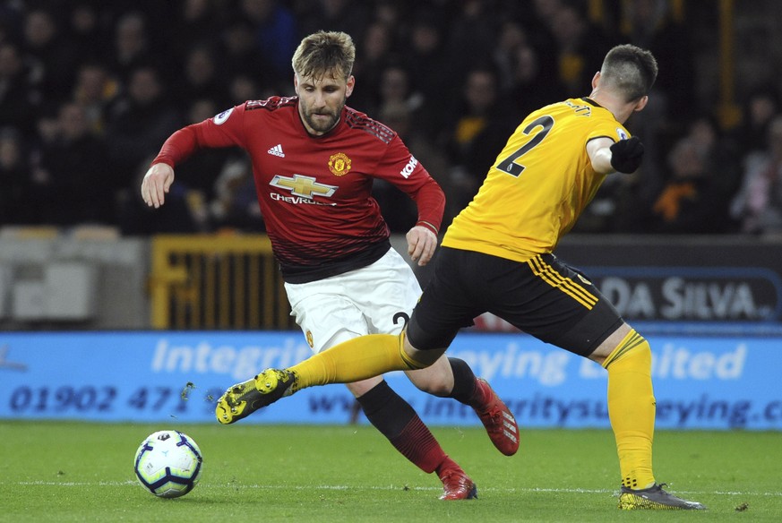 Wolverhampton&#039;s Matt Doherty vies for the ball with Manchester United&#039;s Luke Shaw, left, during the English Premier League soccer match between Wolverhampton Wanderers and Manchester United  ...