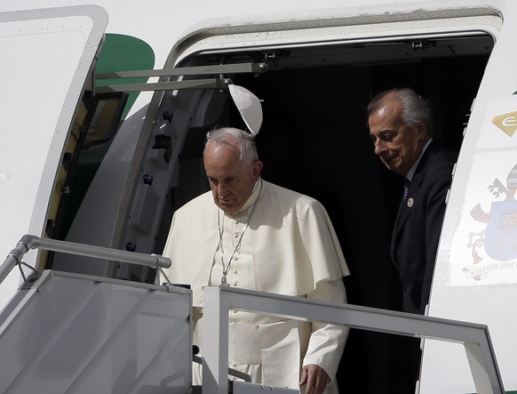 A gust of wind blows Pope&#039;s Francis skull cap upon his arrival at Quito Airport, Ecuador, Sunday, July 5, 2015. The Pontiff is visiting Ecuador, Bolivia and Paraguay on the occasion of his Aposto ...