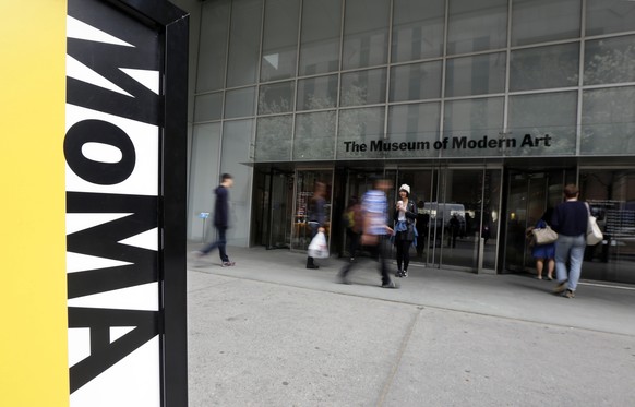 FILE - People walk by the entrance to the Museum of Modern Art, in New York, April 22, 2014. A performer who appeared naked in a show by world-renowned performance artist Marina Abramovic at the Museu ...