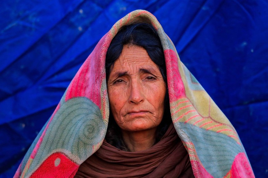 epa10028868 An afghan woman sits outside the temporary shelter after an earthquake in Gayan village in Paktia province, Afghanistan, 23 June 2022. More than 1,000 people were killed and over 1,500 oth ...