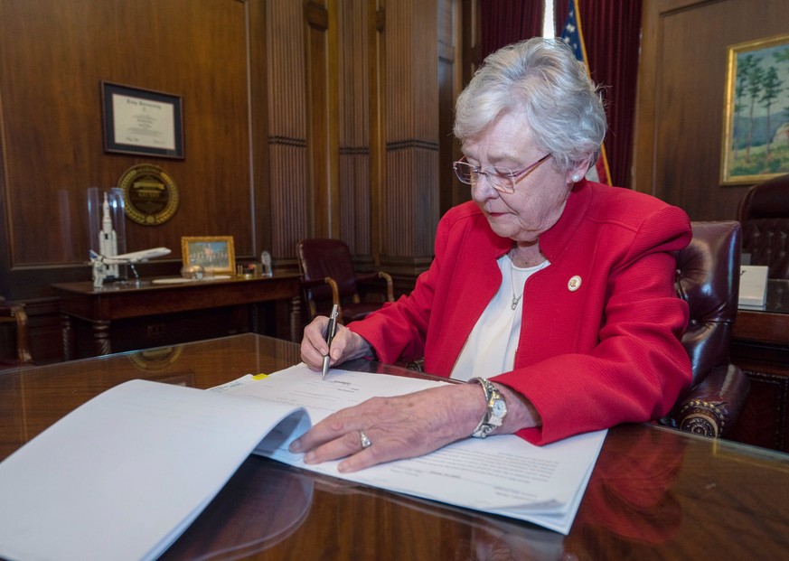 epa07574055 A handout photo made available by Alabama Governor Office shows Governor Kay Ivey signing into law the Alabama Human Life Protection Act, Montgomery, Alabama, USA, 15 May 2019. Alabama&#03 ...