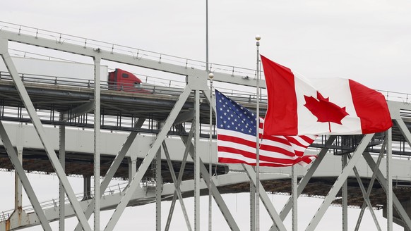 A truck crosses the Blue Water Bridge into Port Huron, Mich., from Sarnia, Ontario, Canada, Wednesday, March 18, 2020. The Canada-U.S. border will be closed to non-essential traffic in both directions ...