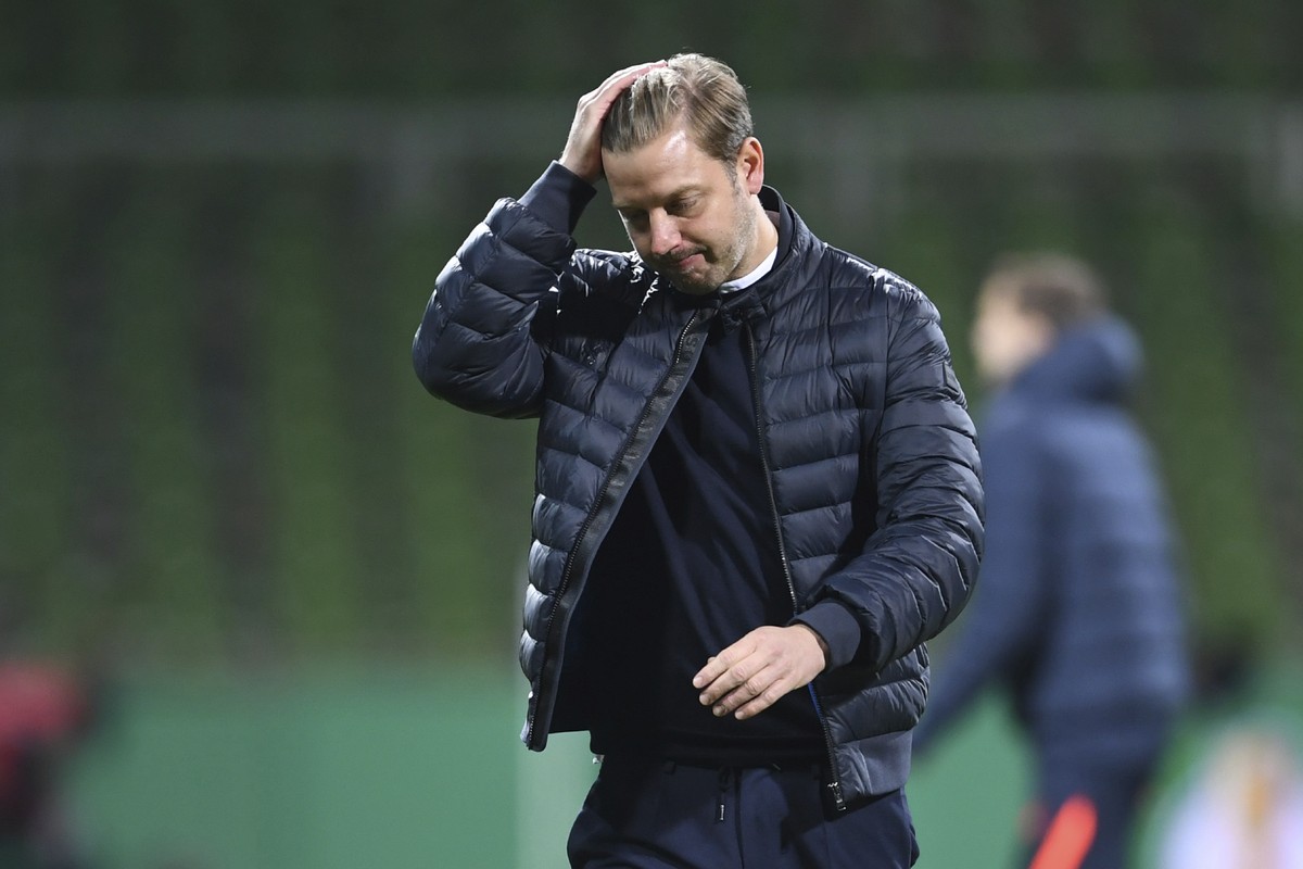 Bremen's head coach Florian Kohfeldt walks in dejection end of the German soccer cup semifinal soccer match between Werder Bremen and RB Leipzig at the Weserstadion stadium in Bremen, Germany, Sa ...