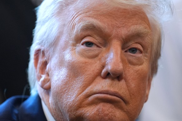 President Donald Trump listens before he signs an executive order reclassifying marijuana as a less dangerous drug, in the Oval Office of the White House, Thursday, Dec. 18, 2025, in Washington. (AP P ...