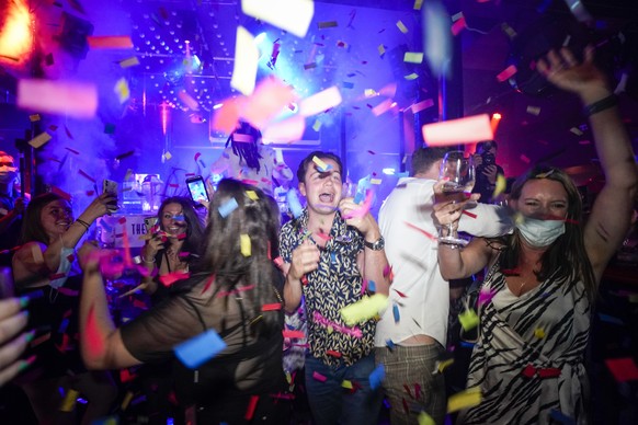 People dance shortly after the reopening, at The Piano Works in Farringdon, in London, Monday, July 19, 2021. Thousands of young people plan to dance the night away at &#039;Freedom Day&#039; parties  ...