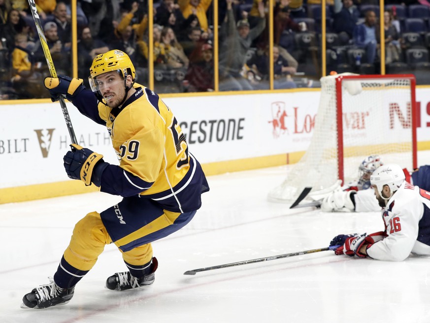 Nashville Predators defenseman Roman Josi (59), of Switzerland, celebrates after scoring a goal against Washington Capitals goalie Philipp Grubauer, upper right, of Germany, and left wing Daniel Winni ...