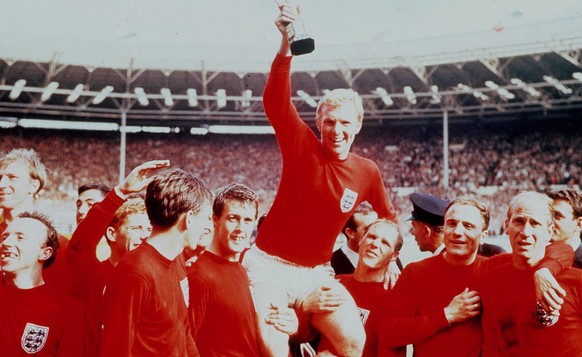 England&#039;s soccer captain Bobby Moore, carried shoulder high by his team mates holds aloft the FIFA World Cup in this July 30 1966 file photo. England defeated Germany 4-2 in the final of the 1966 ...