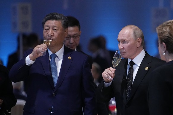 Russian President Vladimir Putin and Chinese President Xi Jinping hold glasses during a festive reception of the BRICS summit in Kazan, Russia, Wednesday, Oct. 23, 2024. (AP Photo/Alexander Zemlianich ...
