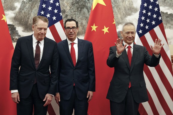 FILE - In this file photo taken Wednesday, May 1, 2019, Chinese Vice Premier Liu He, right, gestures as U.S. Treasury Secretary Steven Mnuchin, center, chats with his Trade Representative Robert Light ...