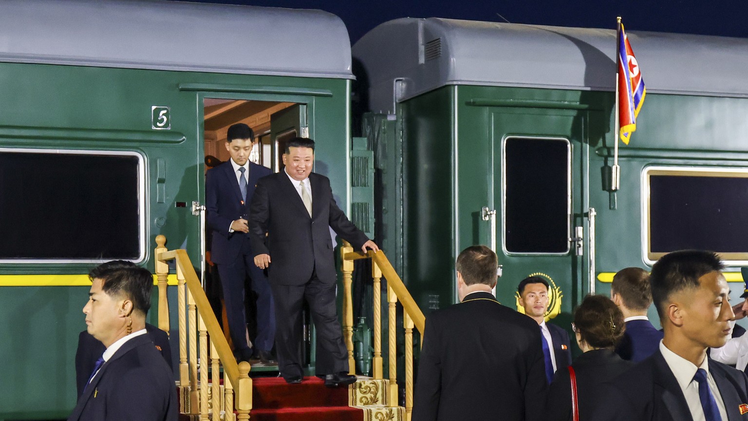 In this photo taken and provided by the Primorsky Krai Administration Press Agency, North Korean leader Kim Jong Un (center) steps off his train after crossing the border into…