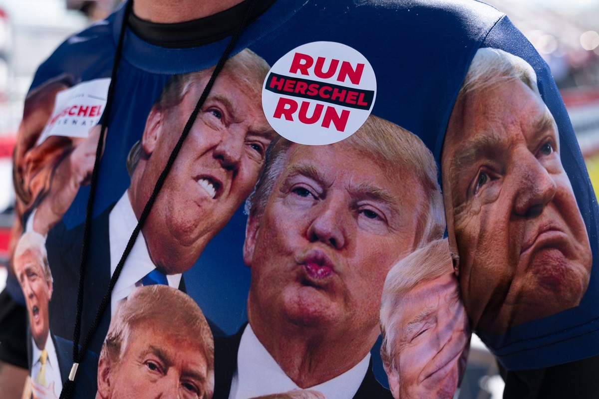 epa09488913 A supporter of former US President Donald Trump wears a shirt featuring the former president's expressions at a rally sponsored by 'Save America' at the Georgia National Fai ...