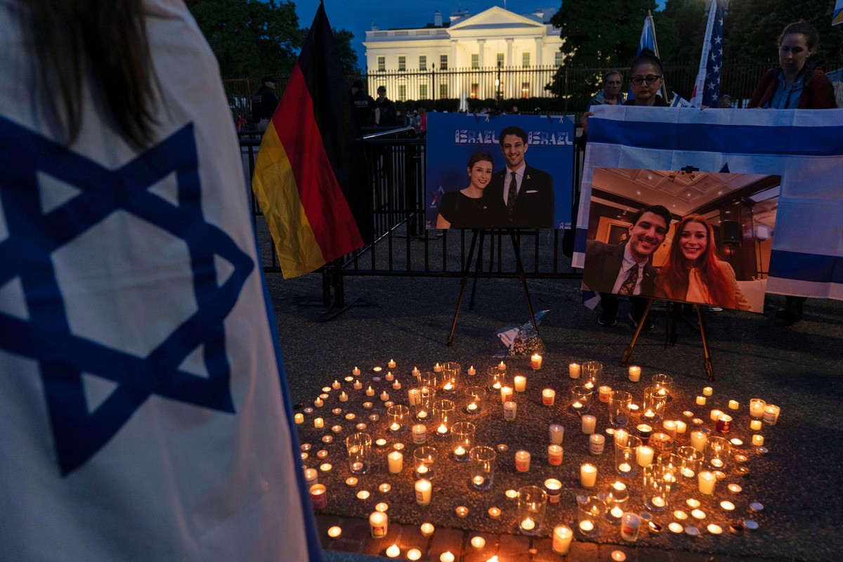People gather to light candles in a makeshift memorial to honor Yaron Lischinsky and Sarah Milgrim who were killed as they left an event at the Capital Jewish Museum in Washington, during a candleligh ...