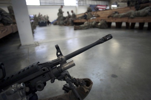 FILE - A U.S. Army soldier&#039;s weapon is shown, Jan. 4, 2020, at Fort Bragg, North Carolina. Two men who forged deep bonds of friendship while serving in the Army in Afghanistan would be arrested i ...