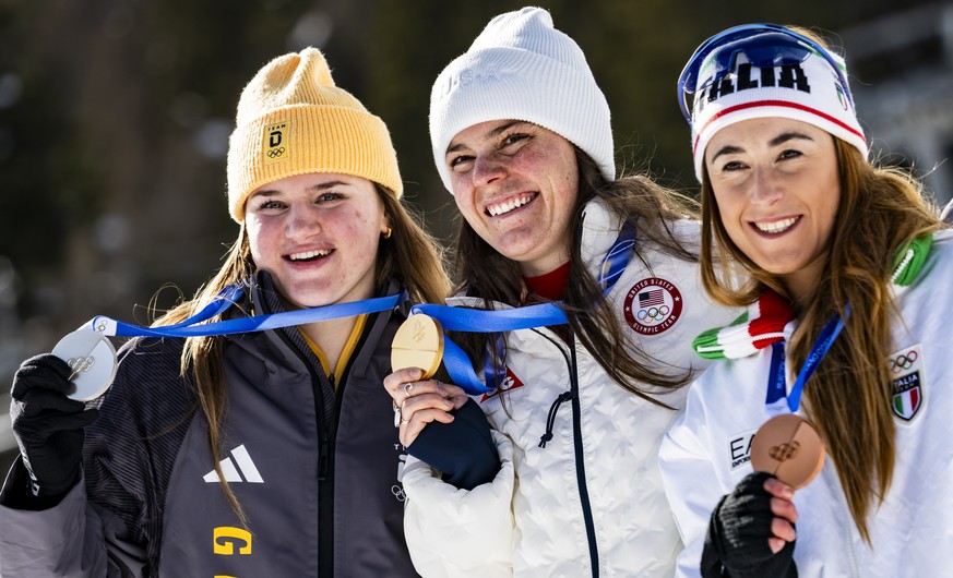 epa12716327 Silver medalist Emma Aicher (L) of Germany, Gold medalist Breezy Johnson (C) of the United States, and Bronze medalist Sofia Goggia (R) of Italy celebrate during the medals ceremony of the ...