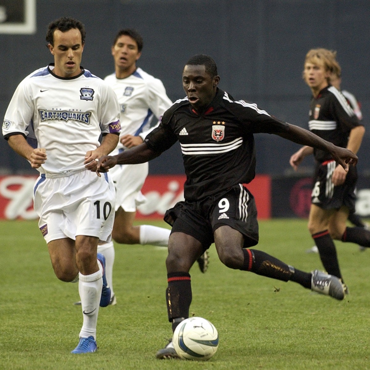 DC United's Freddy Adu, right, moves the ball past San Jose Earthquake's Landon Donovan (10) during second half MLS action at RFK Stadium in Washington, Saturday, April 3, 2004. Adu, 14, bec ...