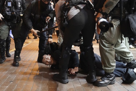 Riot police detain a protester during a demonstration in Hong Kong, Wednesday, Dec. 25, 2019. Clashes resumed in Hong Kong on Tuesday between police and anti-government protesters, some of them donned ...