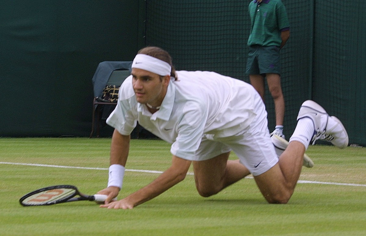 Switzerland's Roger Federer takes a fall during his match against Xavier Malisse of Belgium in their second round men's singles match at Wimbledon, Wednesday June 27, 2001. (KEYSTONE/AP Phot ...