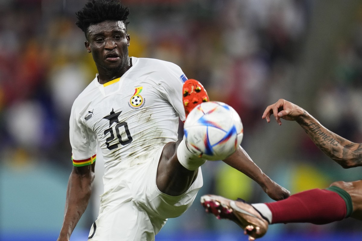 Ghana's Mohammed Kudus battles for the ball with Portugal's Joao Cancelo during a World Cup group H soccer match at the Stadium 974 in Doha, Qatar, Thursday, Nov. 24, 2022. (AP Photo/Manu Fe ...