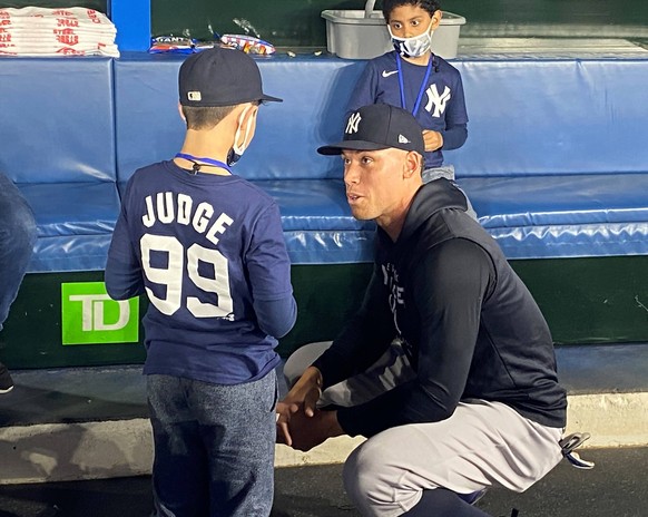 May 4, 2022, Toronto, ON, CANADA: Nine-year-old Derek Rodriguez meets Yankees slugger Aaron Judge in the New York dugout on Wednesday afternoon at Rogers Centre before the start of American baseball a ...