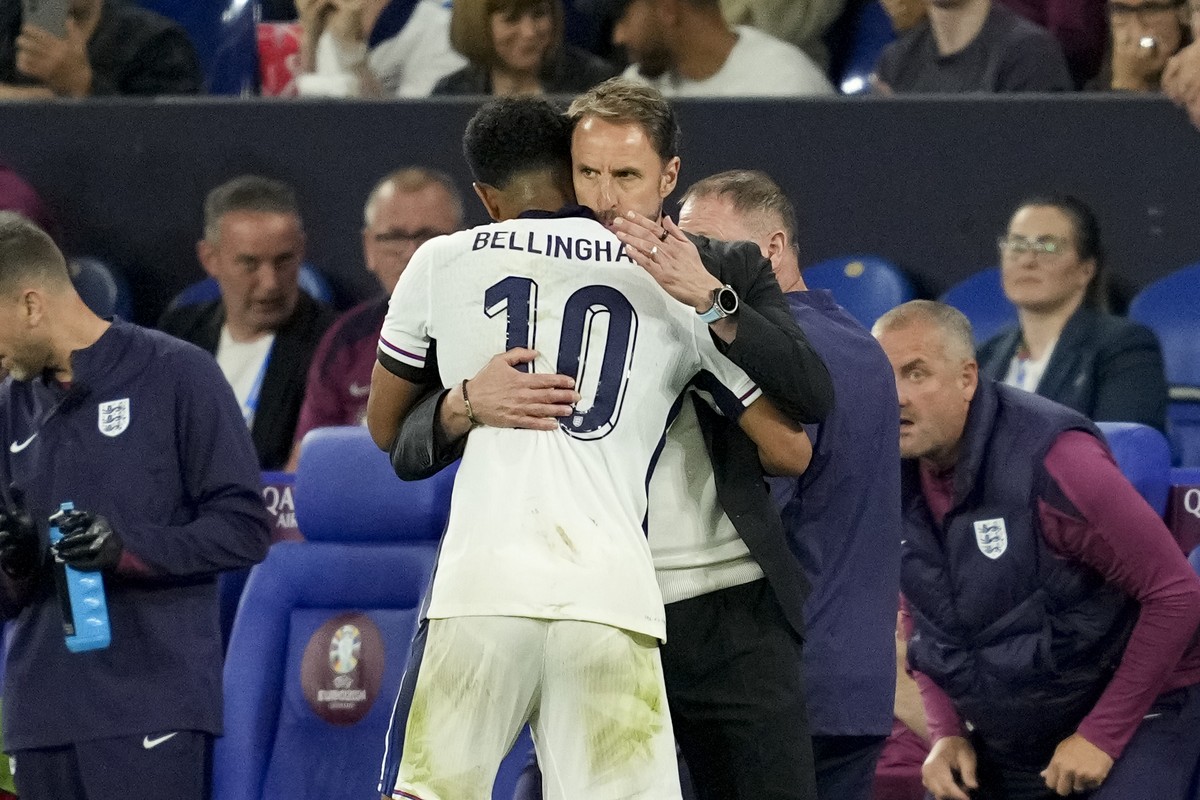England's Jude Bellingham gets a hug from England's manager Gareth Southgate after being substituted during a Group C match between Serbia and England at the Euro 2024 soccer tournament in G ...