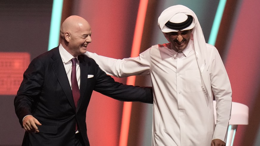 FIFA President Gianni Infantino, left, and Emir of Qatar Sheikh Tamim bin Hamad Al Thani leave the stage before the 2022 soccer World Cup draw at the Doha Exhibition and Convention Center in Doha, Qat ...